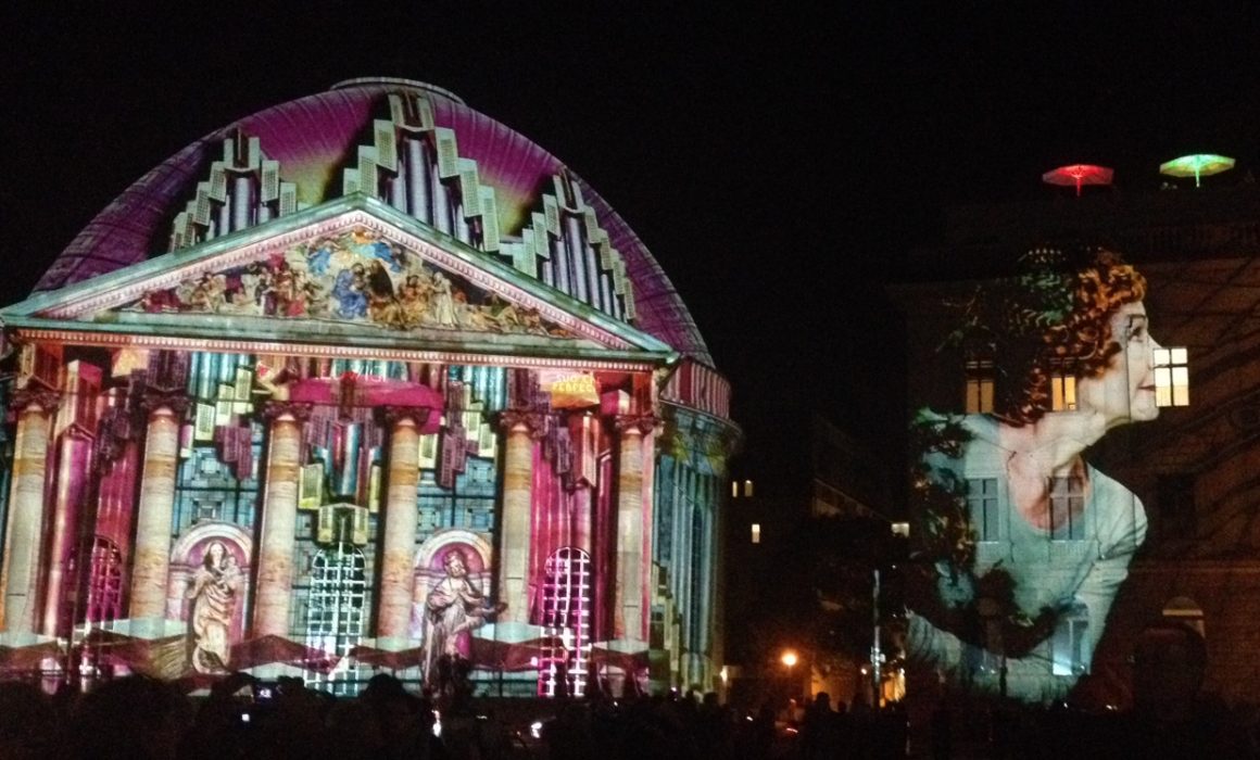 Colourful light display on St. Hedwigs Cathedral and the Hotel de Rome, Berlin